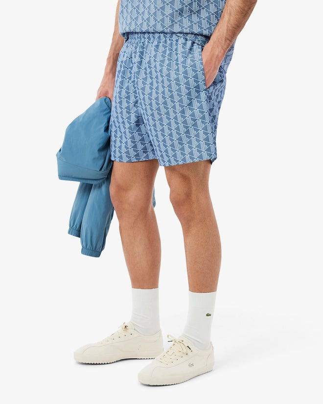Shorts de banho de comprimento médio com estampa de monograma